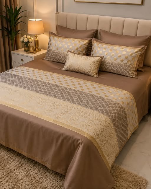 Gold and taupe designer bedlinen with a patterned runner and coordinating cushions